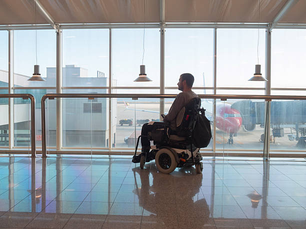 istock Person with disability using wheelchair at airport 2247655834