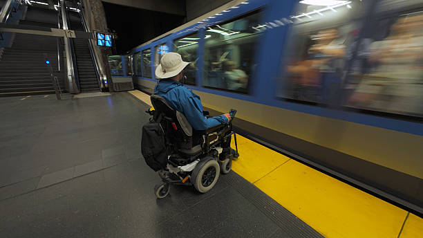 istock Man with disability, a wheelchair user, waiting for a train on a metro platform 2247656215