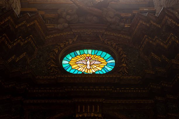 Minneapolis, Minnesota, July 24, 2014: The photo showcases an awe-inspiring mosaic ceiling in a chapel, where countless tiny, colourful tiles come together to form a breathtaking design.  The ceiling is adorned with radiant gold and green tiles that shimmer as light filters in, creating a divine, ethereal glow.  The sheer complexity of the mosaic, combined with the harmonious blend of colours and the masterful artistry, creates a sense of spiritual reverence and architectural beauty.