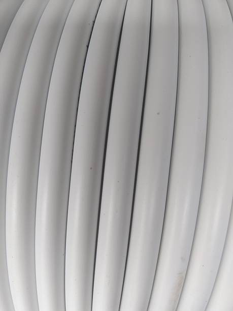 istock Vertical Close-up of White Coiled PVC Cable or Pipe 2247656264