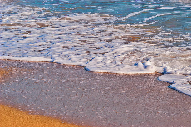 istock White ocean foam washing golden beach sand 2247656422