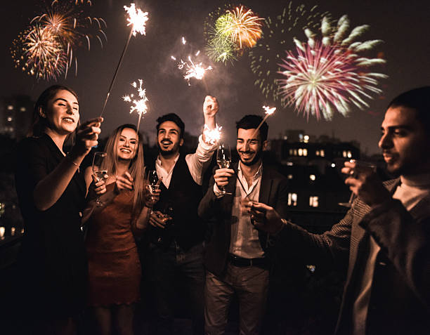 istock friends celebrate the new year in the rooftop 2247657947