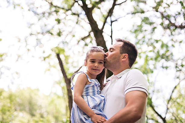 istock Father with his daughter having fun outside in forest 2247658600