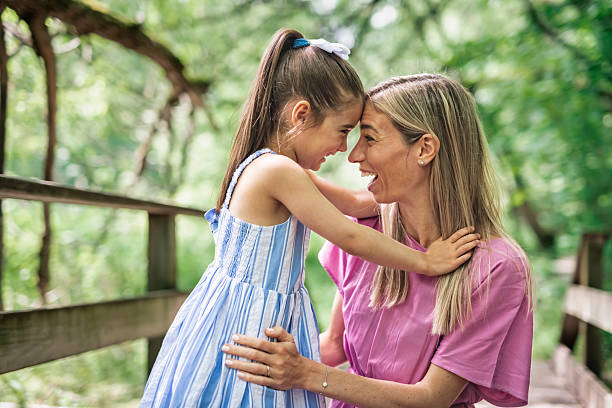 istock mother with his daughter having fun outside in forest 2247658656