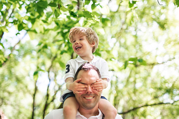 istock Father with his son having fun outside in forest 2247658723