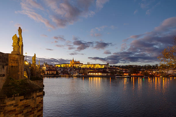 istock Castle of Prague and Charles bridge reflected on Vltava river at sunset 2247658785