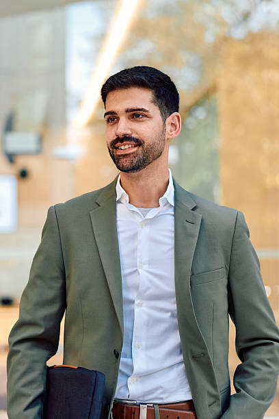istock Confident businessman standing working in modern office environment 2247659474