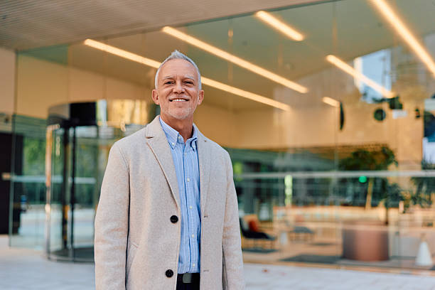 istock Senior businessman smiling confidently outside modern office building 2247660290