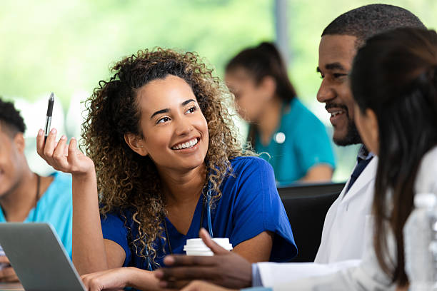 istock Medical students and professionals collaborating and learning together in a bright indoor classroom setting. 2247660485