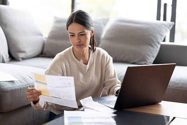 istock Woman paying bills online at home 2247662539