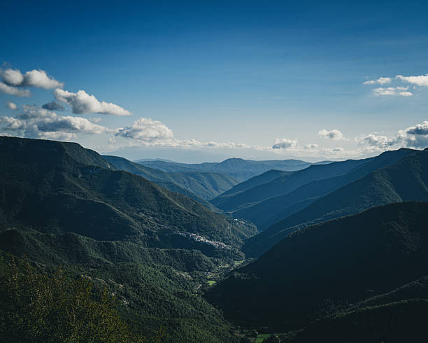istock Deep Valley Landscape with Layered Green Mountains and Small Village Below 2247662843