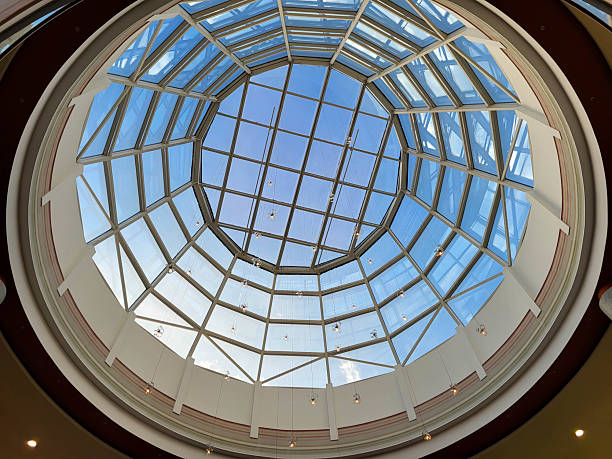 istock A round glass decorative ceiling with a modern design against a blue sky background. 2247663389