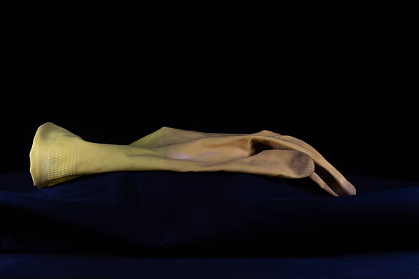 single used dirty washing up rubber glove isolated on a black background