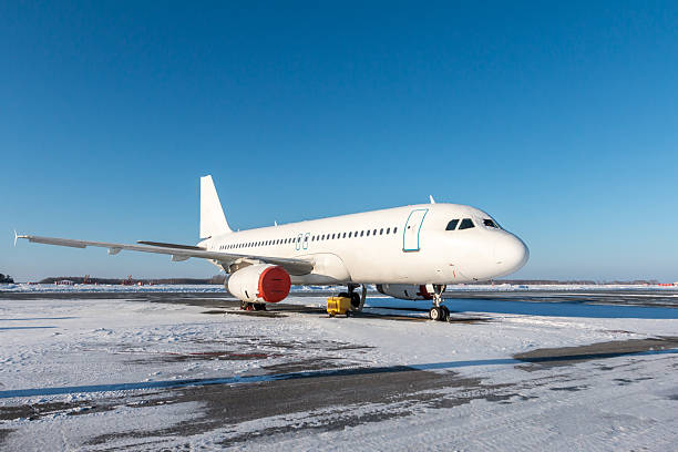 istock White passenger plane on the winter airport 2247665538