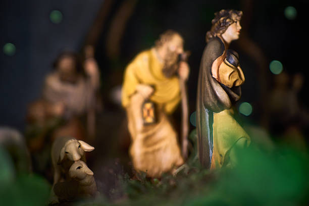 istock A Christmas manger scene with beautifully carved figures, including shepherds and animals. Adorable sheep in the foreground. 2247665720