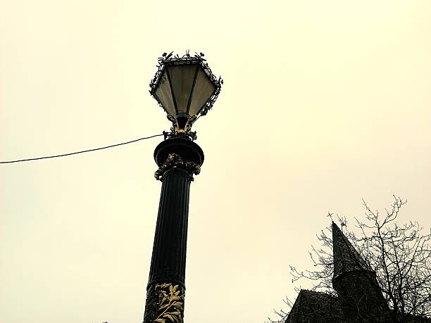Low angle view of a victorian street lamp and church roof