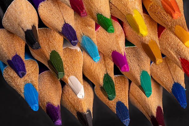 istock Colorful pencils arranged in a tight cluster on a black background 2247666064