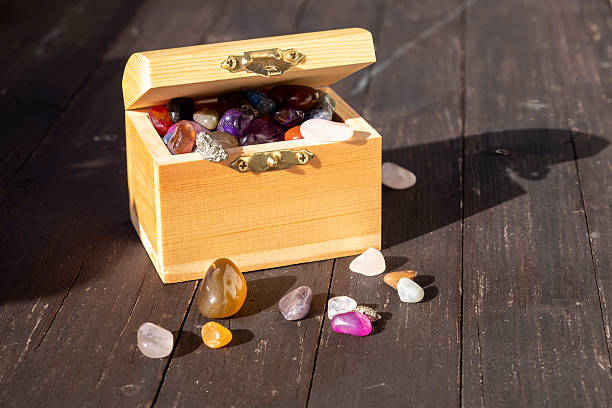 Small wooden treasure chest with many gemstones