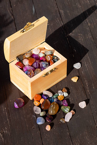 istock Small wooden treasure chest with many gemstones 2247668133