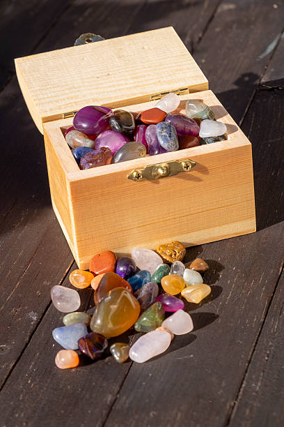 in the morning sunshine through on colorful gemstones. gemstones are falling scattered about on the beach.