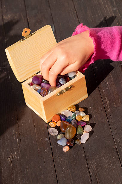 Small wooden treasure chest with many gemstones