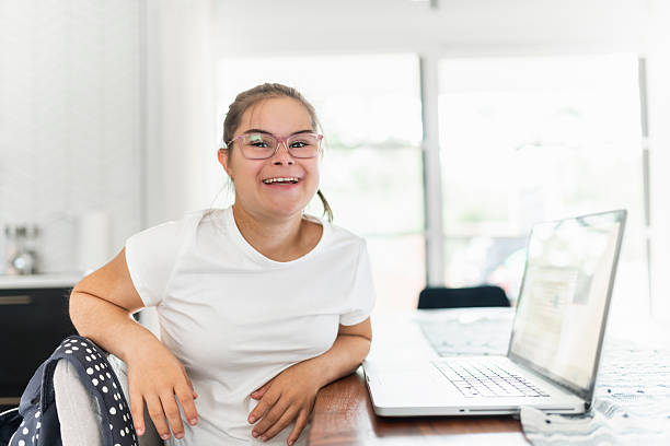 istock child girl having great time sit on kitchen table with laptop 2247669158