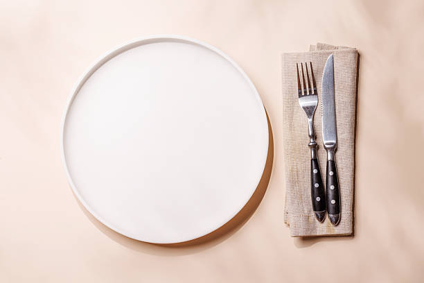 istock Empty plate on beige background, food mockup with natural light 2247669403