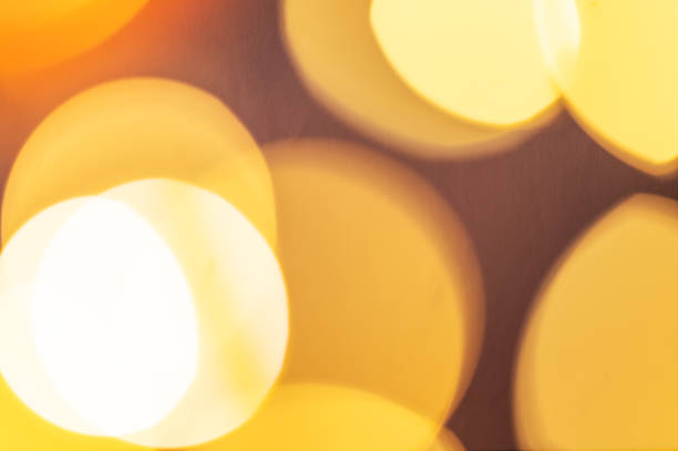 istock Yellow lights with a bokeh effect on a dark background. 2247670161