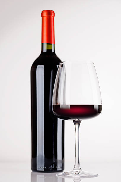 istock Red wine bottle and glass on white background 2247670568