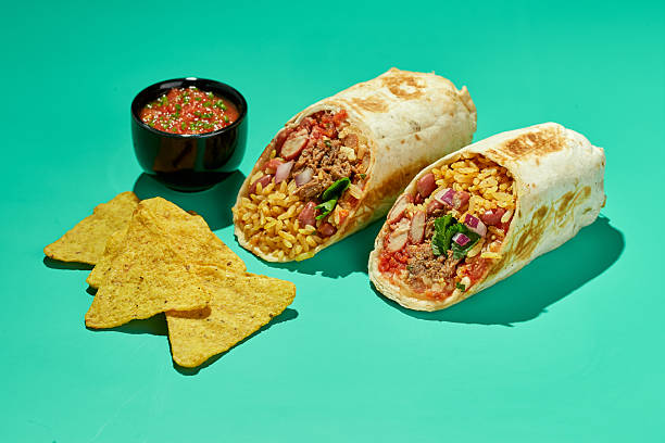 Traditional Mexican Beef Burrito with Nachos Chips and Salsa Sauce.