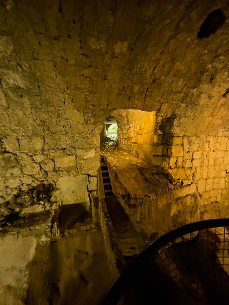 istock Historic stone passage with stream and walkway in a subterranean river vault 2247672886