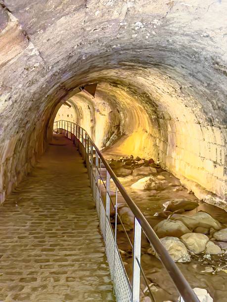 istock Historic stone passage with stream and walkway in a subterranean river vault 2247672908