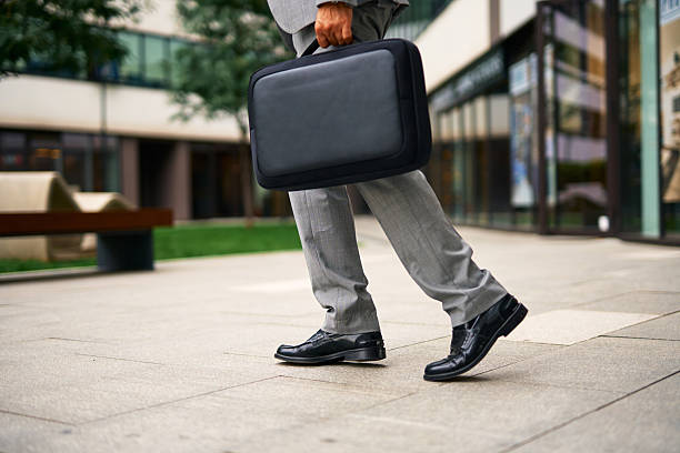 istock Business person walking to work carrying briefcase 2247675952