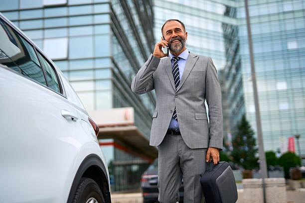 istock Mature businessman making phone call arriving at office building 2247676111