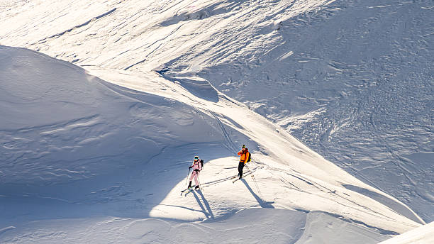 istock Two Skiers on a Snowy Mountain Slope 2247676676