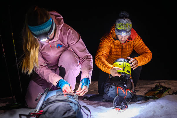 istock Two Climbers Prepare Gear under Headlamps in Snowy Night 2247676715