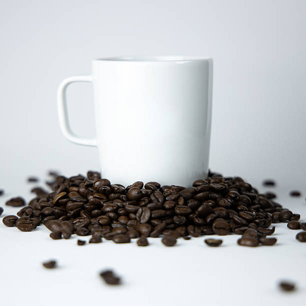 Roasted Arabica coffee beans, ready to make coffee that people like to drink. Placed in a Black coffee cup paper on the background. Looks beautiful and appetizing. Drink.