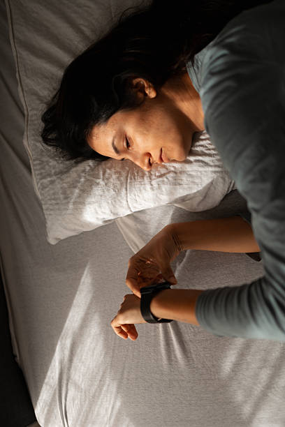istock Woman checking smartwatch in bed after waking up 2247677241