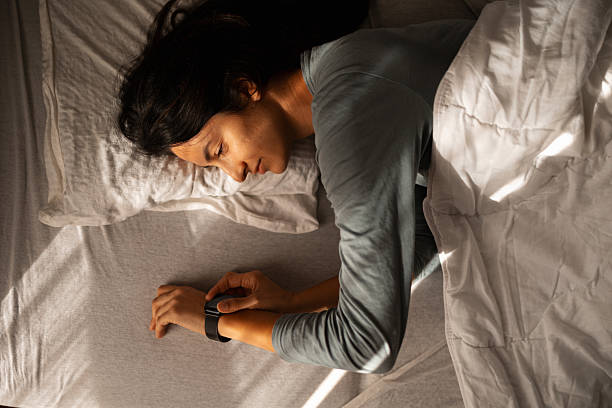 istock Woman waking up checking smartwatch sleep tracker 2247677251