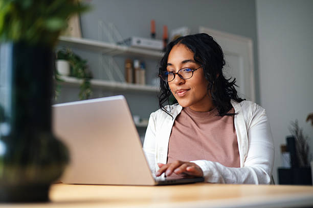 istock Focused Woman Working On Laptop At Home Office For Personal Or Professional Tasks 2247678584