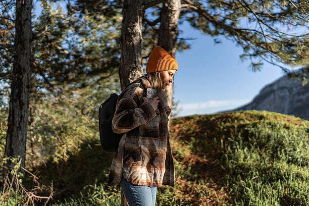 istock Woman hiking in nature using smart phone 2247679166