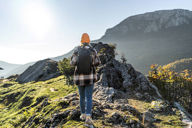 istock Woman hiking mountain trail exploring nature adventure 2247679365