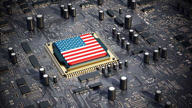 istock Microchip with the American flag and star symbols is carefully installed on a high-tech mainboard 2247680527
