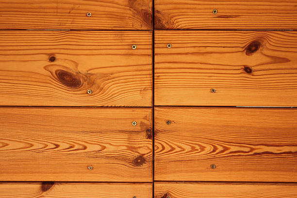 A clean arrangement of wooden planks featuring visible natural grain, used for flooring or wall cladding.