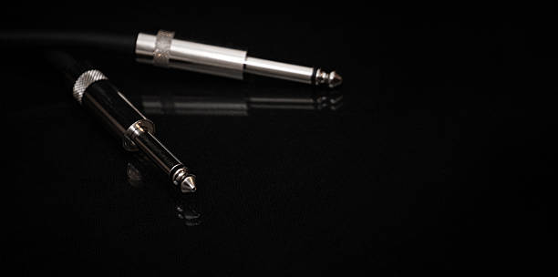 istock Two silver TRS connectors for the analog audio signal are placed against a black background. Professional jack connectors for sound equipment. Audiophile technologies concept. 2247682132