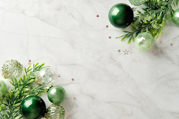 istock Two corner frame of green Christmas baubles and spruce branches on marble background 2247682401