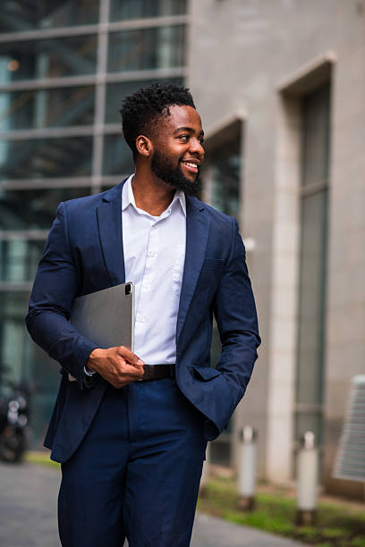 istock Young businessman walking with tablet outdoors 2247682451