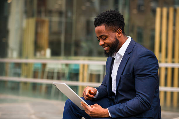 istock Young businessman working on tablet outdoors 2247682698