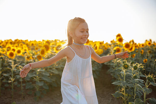 istock Child playing in sunflower field on sunny summer day 2247685095