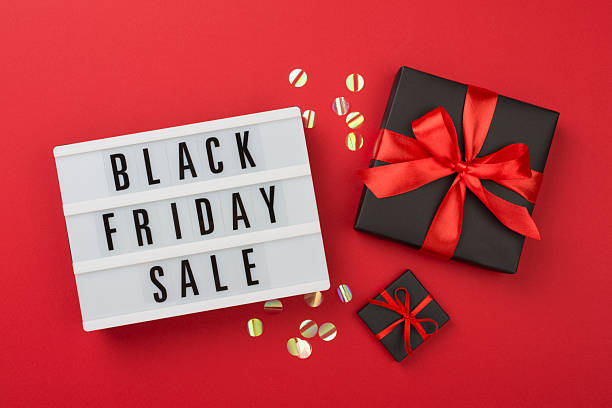 istock Light box with Black friday sale text and gift box on color background, top view 2247685215